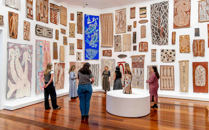 Visitors viewing Indigenous art at National Gallery of Victoria during Best of NGV Experiences Tour.