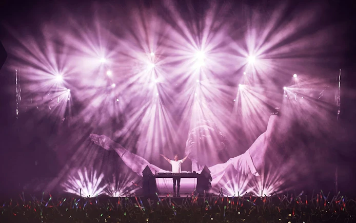 David Guetta performing at F*** ME I'M FAMOUS! in Ushuaia Ibiza with vibrant light show.