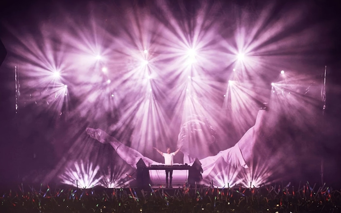David Guetta performing at F*** ME I'M FAMOUS! in Ushuaia Ibiza with vibrant light show.