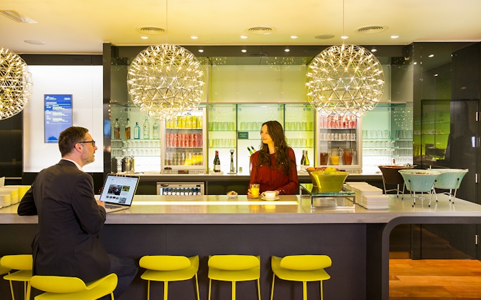 Eurostar Business Premier Lounge in Brussels with guests at the bar.