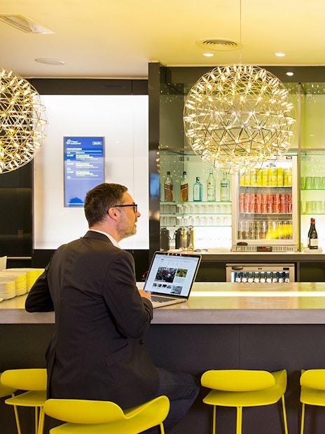 Eurostar Business Premier Lounge in Brussels with guests at the bar.