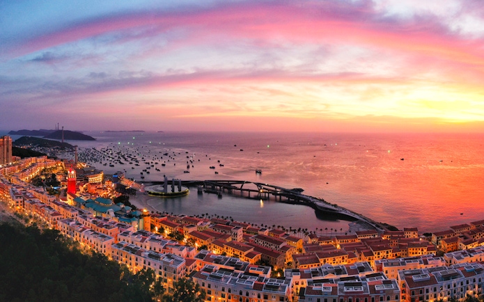 Sunset view over Hon Thom island with colorful buildings and boats in Phu Quoc.