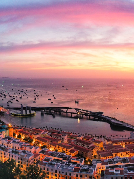 Sunset view over Hon Thom island with colorful buildings and boats in Phu Quoc.