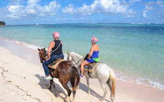 Horseback riding along the shore at Macao Beach, Dominican Republic.