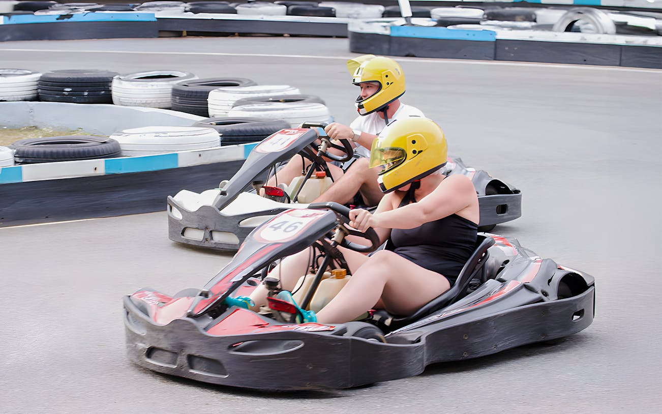 Couple racing go-karts at Outdoor Karting, Bali Hai Pier, Pattaya.