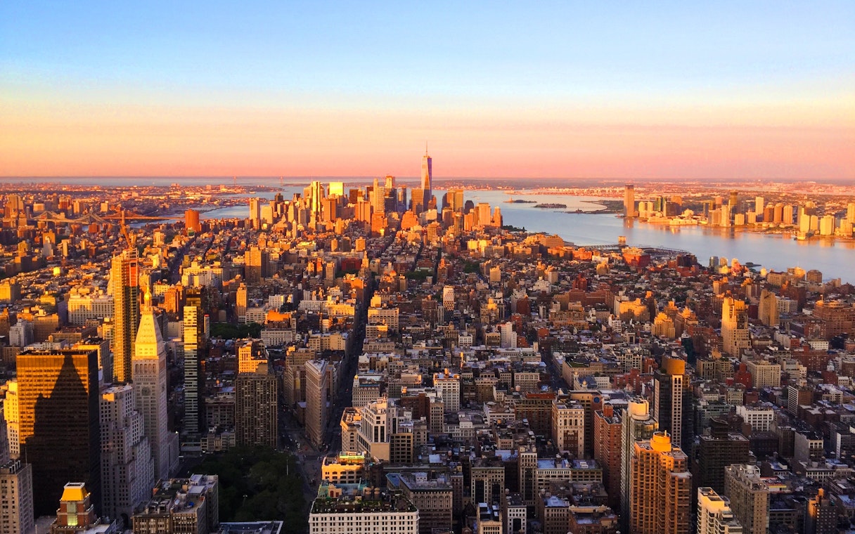 New York City skyline view from Empire State Building at sunset.
