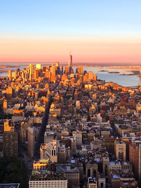 New York City skyline view from Empire State Building at sunset.