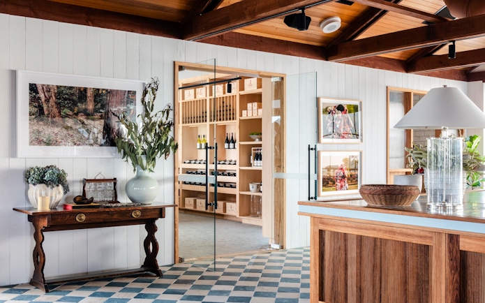Hunter Valley wine tasting room with bottles displayed on wooden shelves.
