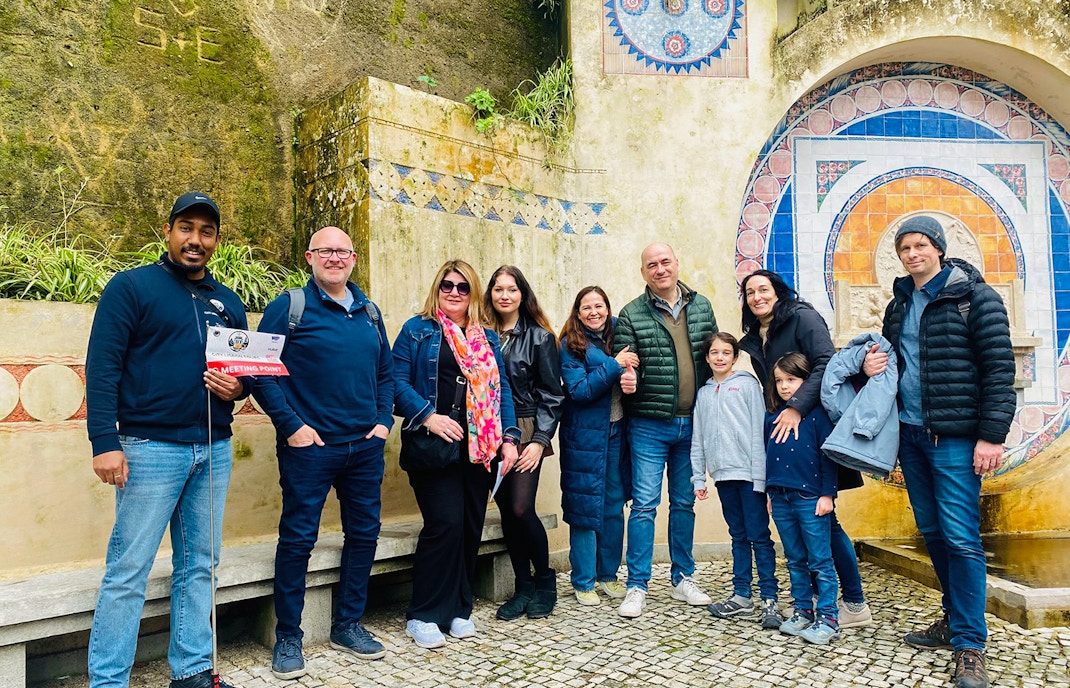Tourists with guide at Quinta da Regaleira fountain, Sintra, Portugal.