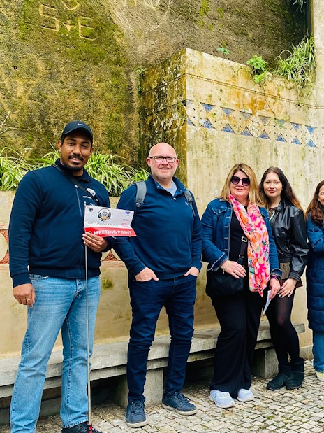 Tourists with guide at Quinta da Regaleira fountain, Sintra, Portugal.
