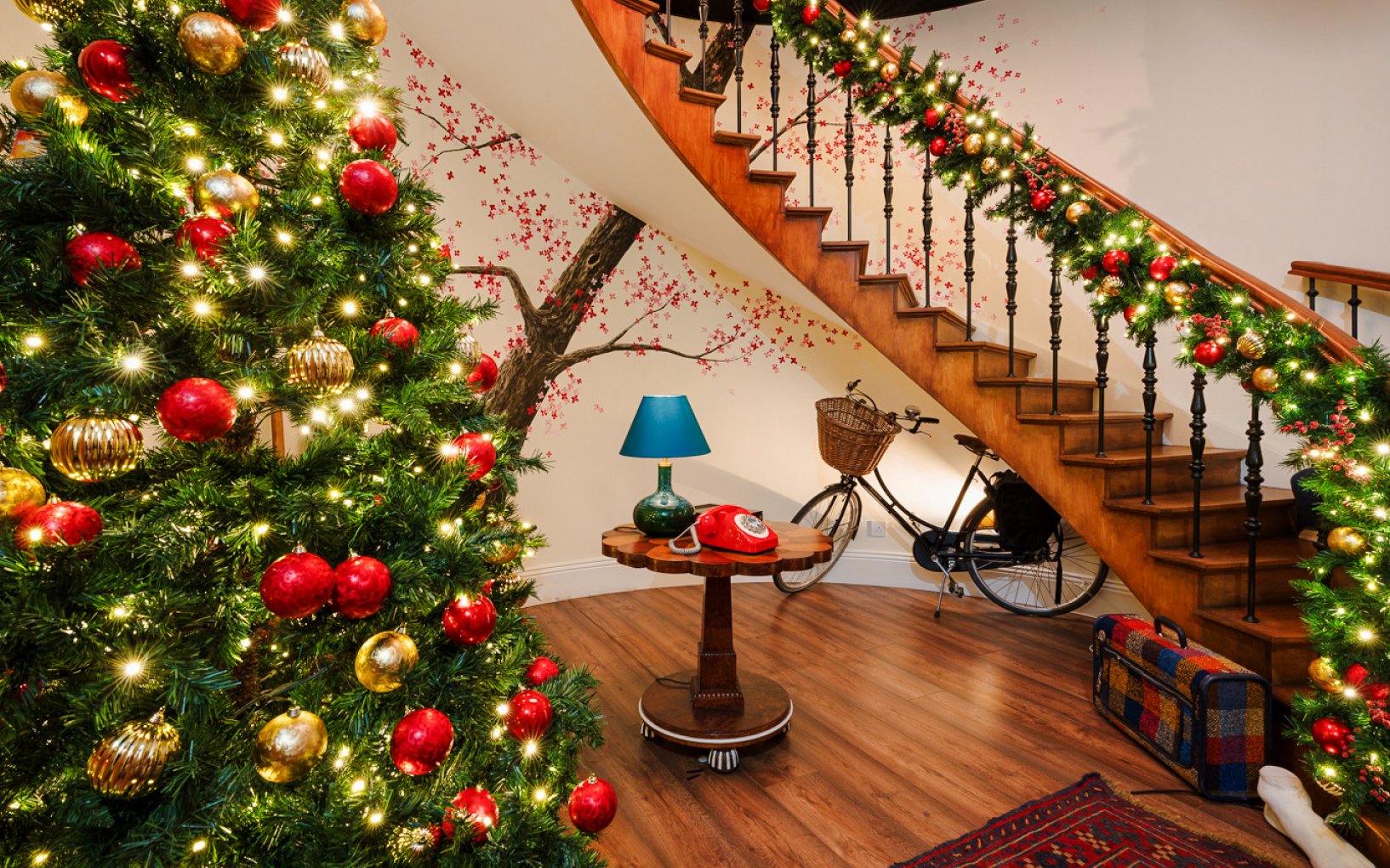 Christmas decorations on a staircase and tree at Paddington experience, London.