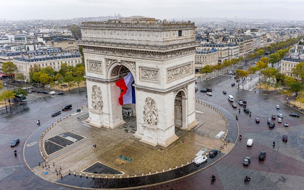 Arc de Triomphe aerial view with surrounding traffic in Paris, France.