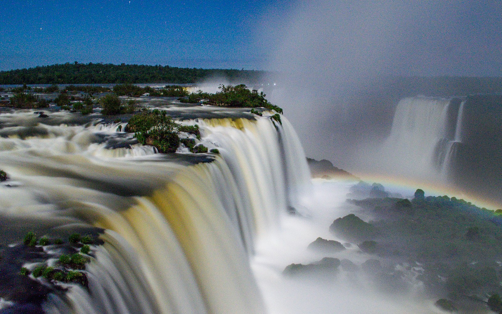 Rainbow over Iguazu Falls at night, a phenomenon called Moonbow Nights