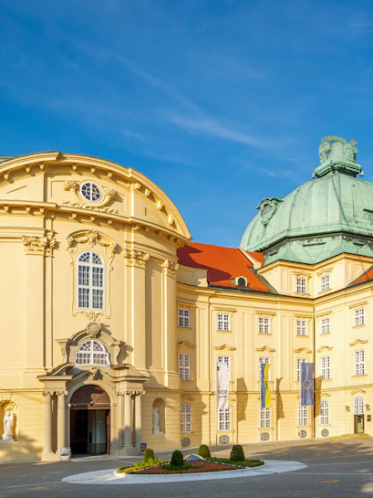 Klosterneuburg Monastery's baroque architecture in Vienna, Austria, under a clear blue sky.