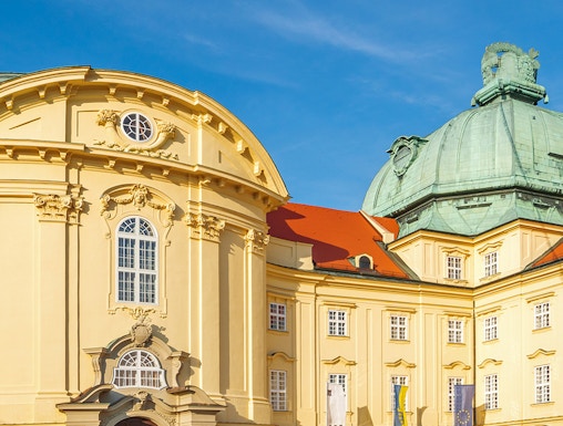 Klosterneuburg Monastery's baroque architecture in Vienna, Austria, under a clear blue sky.