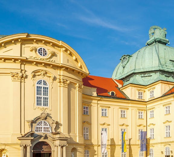 Klosterneuburg Monastery's baroque architecture in Vienna, Austria, under a clear blue sky.