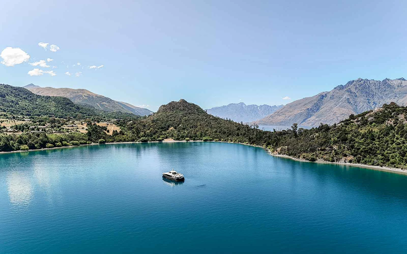 Cruise boat on Lake Wakatipu with mountain backdrop, Queenstown, New Zealand.