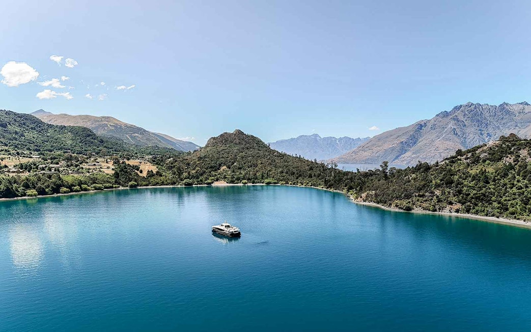 Cruise boat on Lake Wakatipu with mountain backdrop, Queenstown, New Zealand.