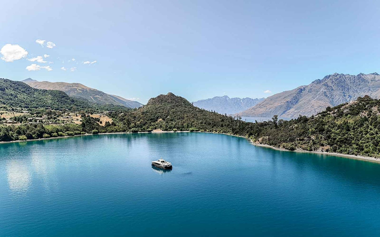 Cruise boat on Lake Wakatipu with mountain backdrop, Queenstown, New Zealand.