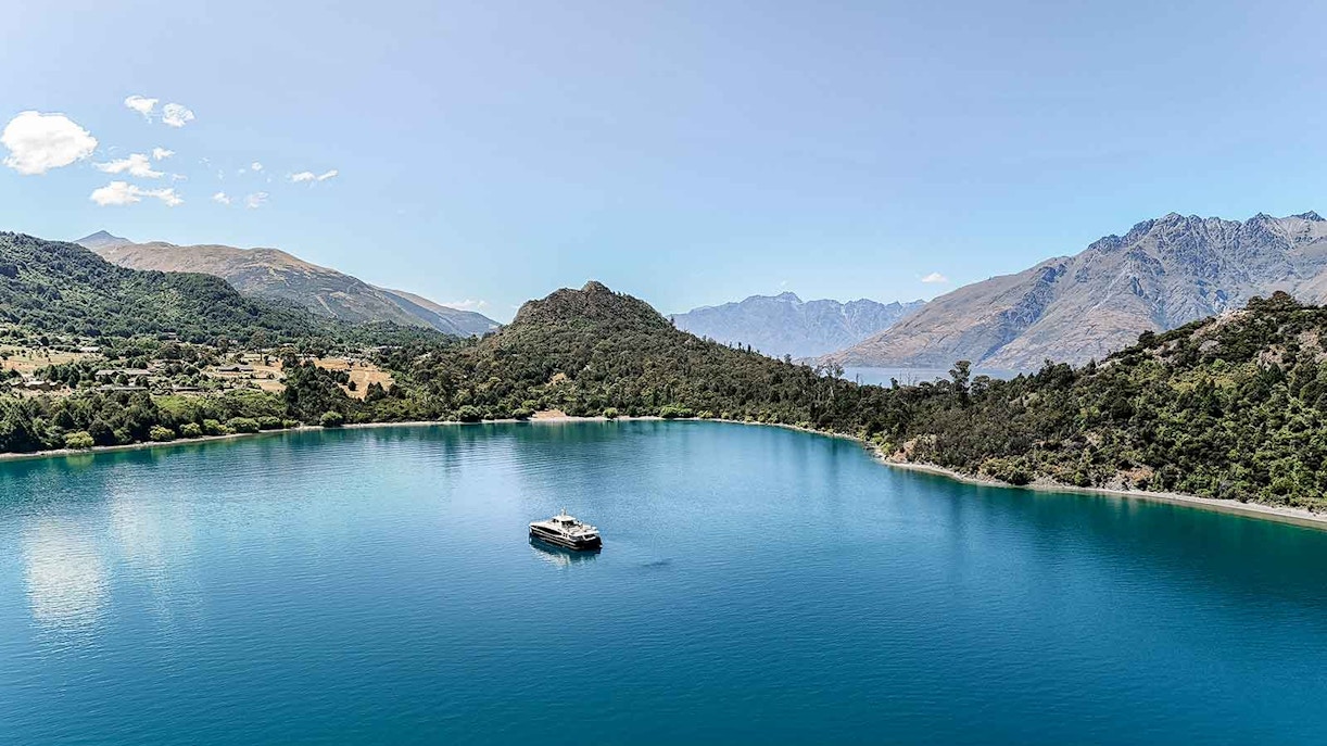 Cruise boat on Lake Wakatipu with mountain backdrop, Queenstown, New Zealand.