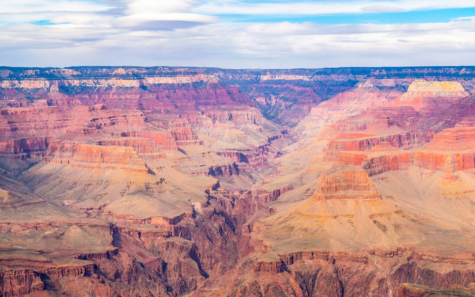 Grand Canyon aerial view, showcasing vast rock formations and Colorado River, National Park, USA.