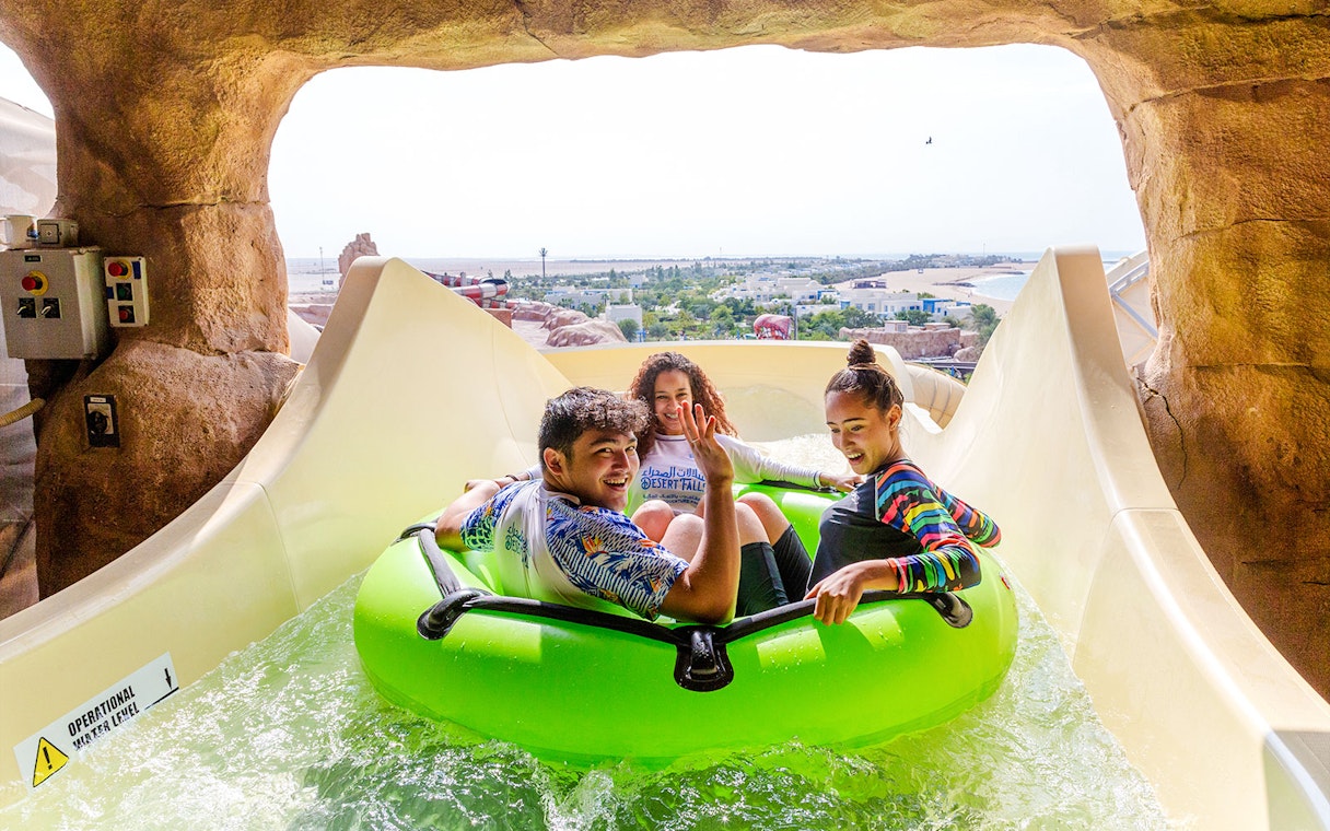 Group enjoying water slide ride in Doha.