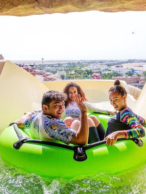 Group enjoying water slide ride in Doha.