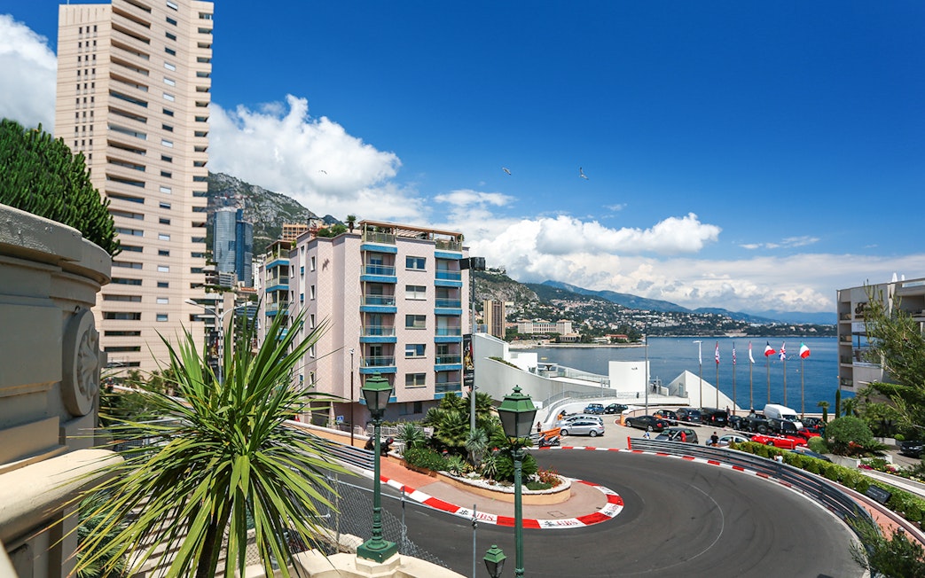Monte Carlo F1 circuit with cityscape and harbor in Monaco.