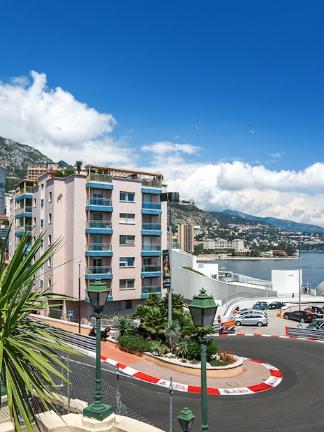 Monte Carlo F1 circuit with cityscape and harbor in Monaco.