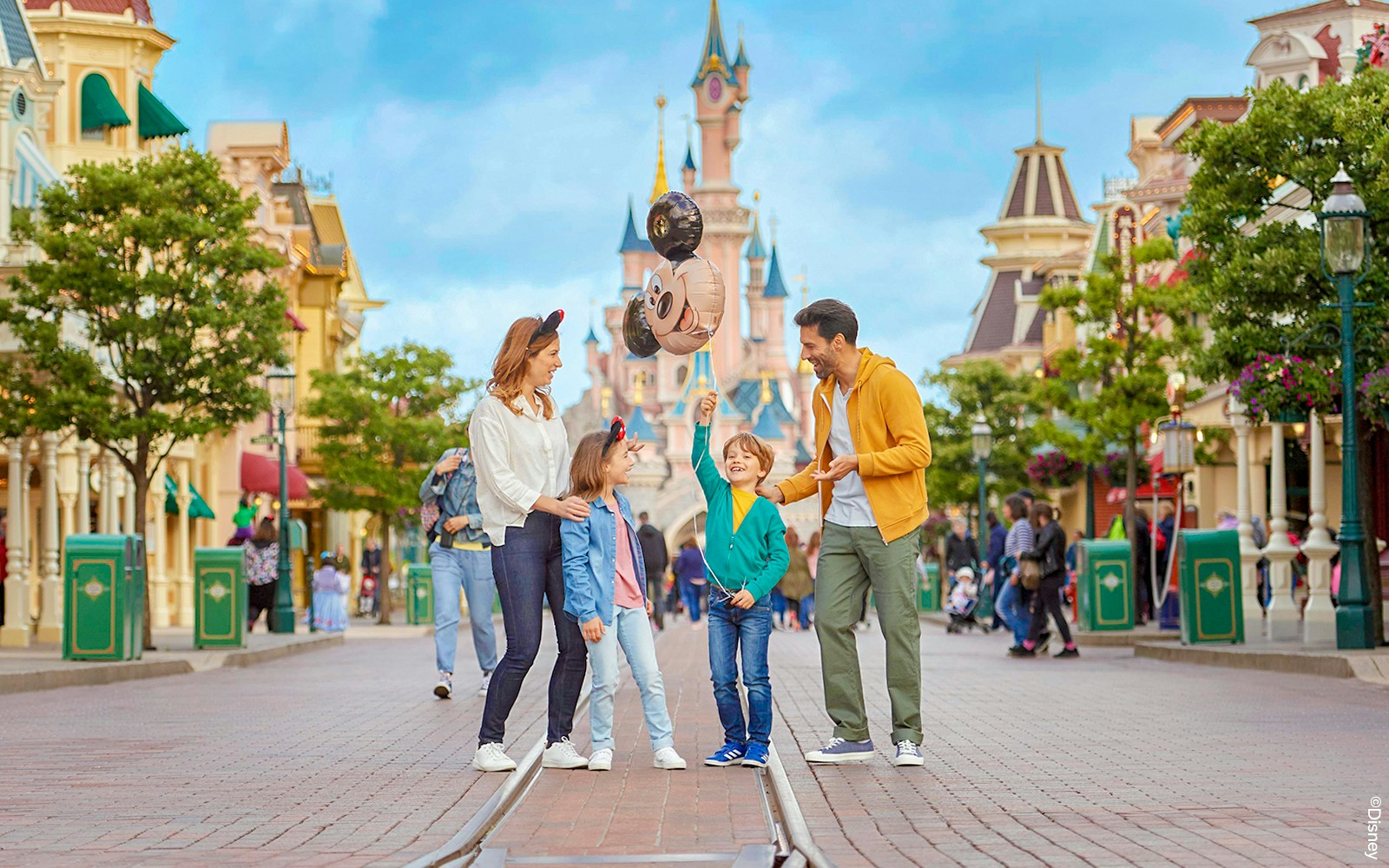 Family enjoying Halloween festivities at Disneyland Paris with Mickey Mouse decorations