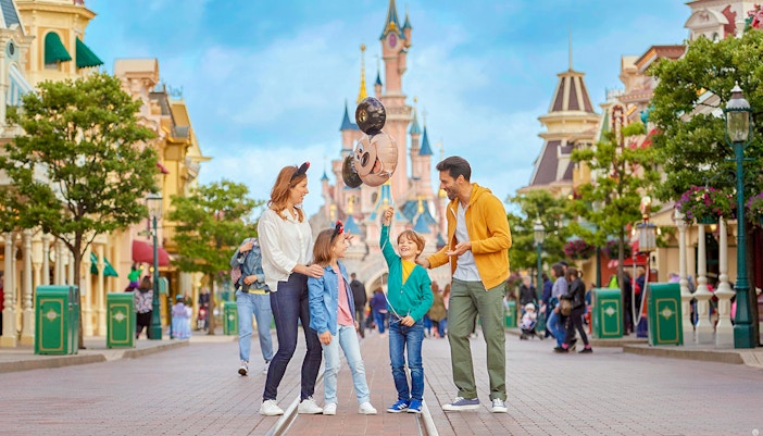 Family enjoying at Disneyland Paris with Mickey Mouse decorations