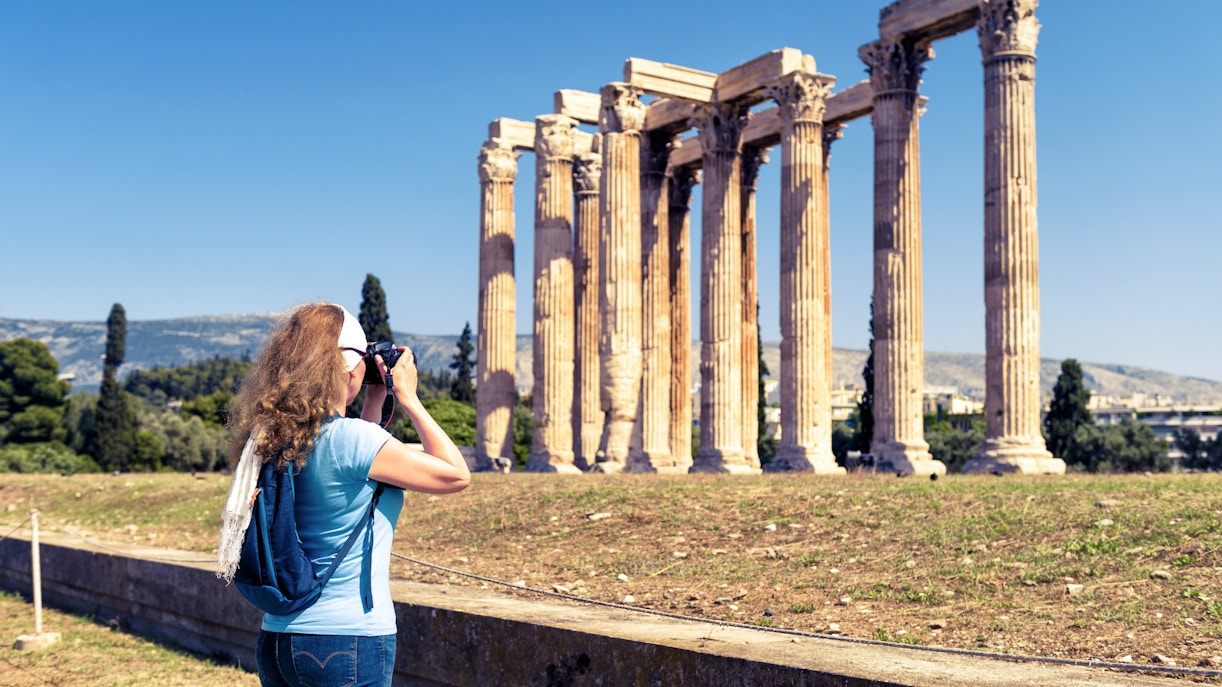 Temple of Olympian Zeus ruins in Athens, Greece with ancient columns against a clear blue sky.