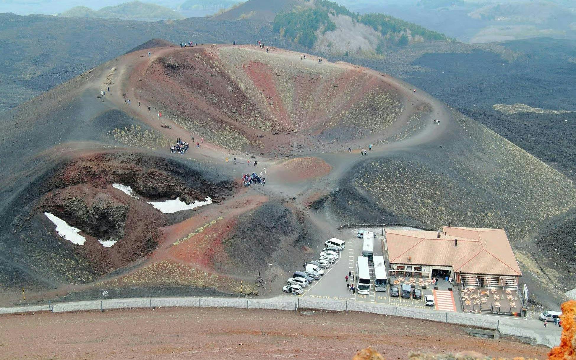 Mount Etna crater with tourists walking along the rim, Sicily, Italy.