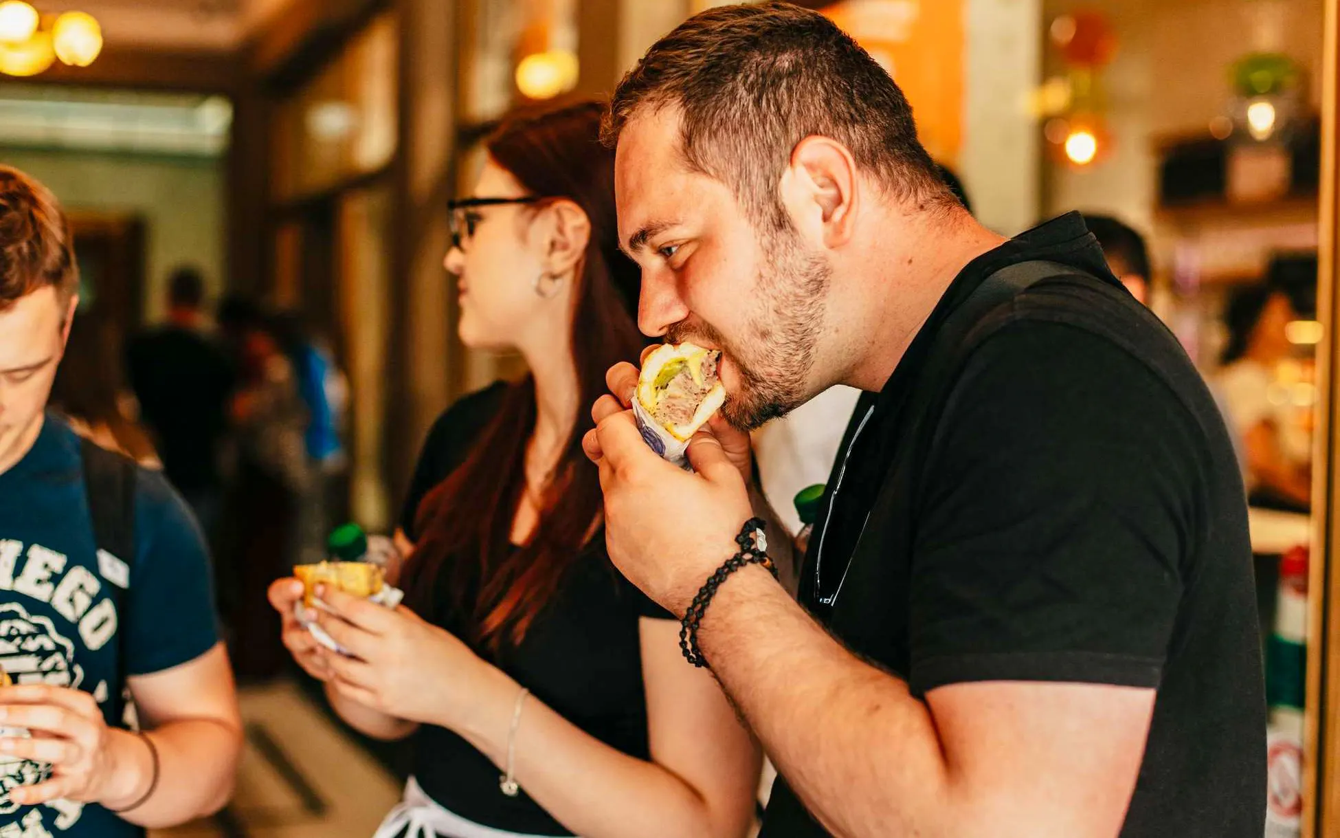 People enjoying local cuisine on a food walking tour in Prague Old Town.