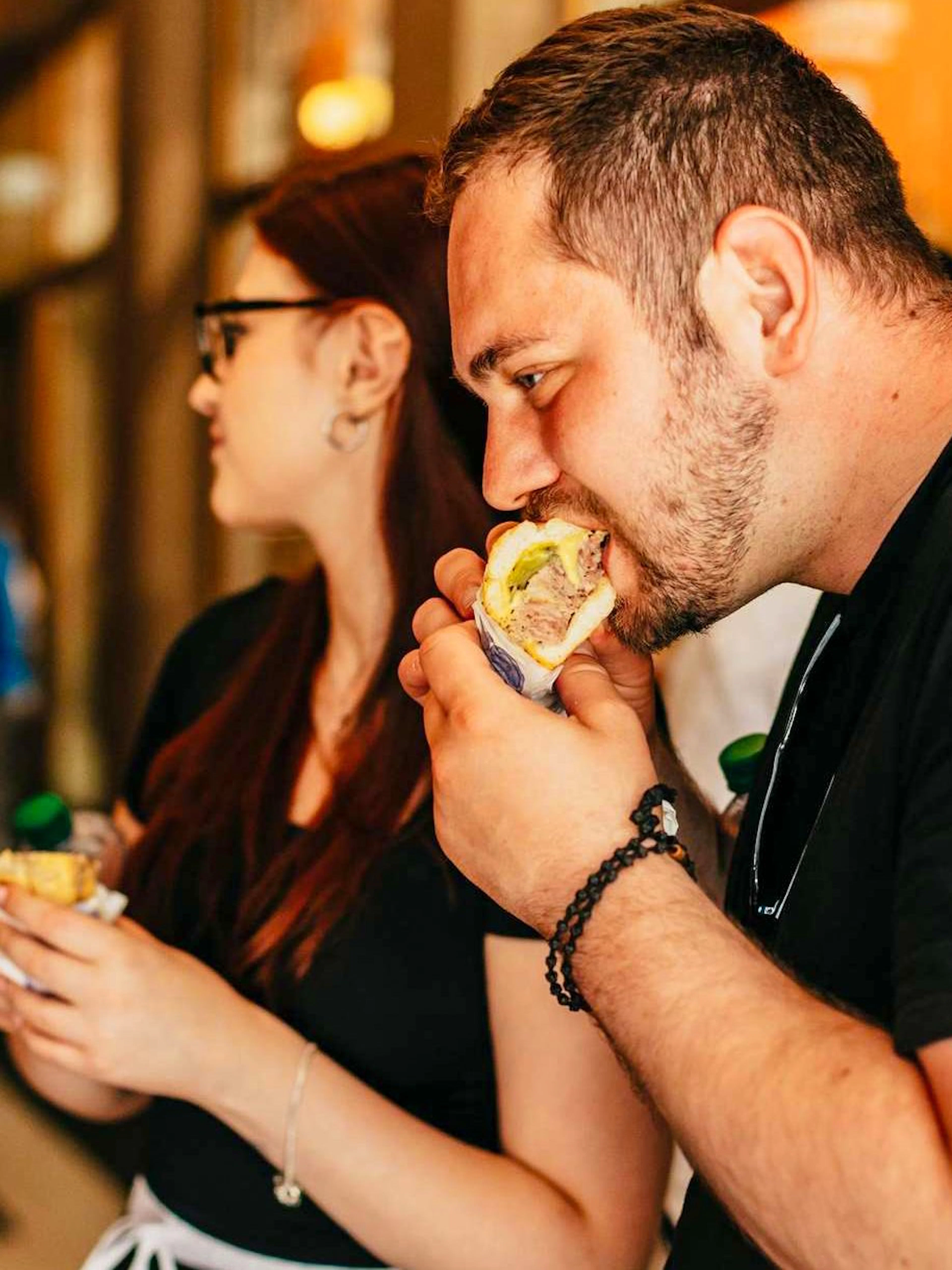 People enjoying local cuisine on a food walking tour in Prague Old Town.