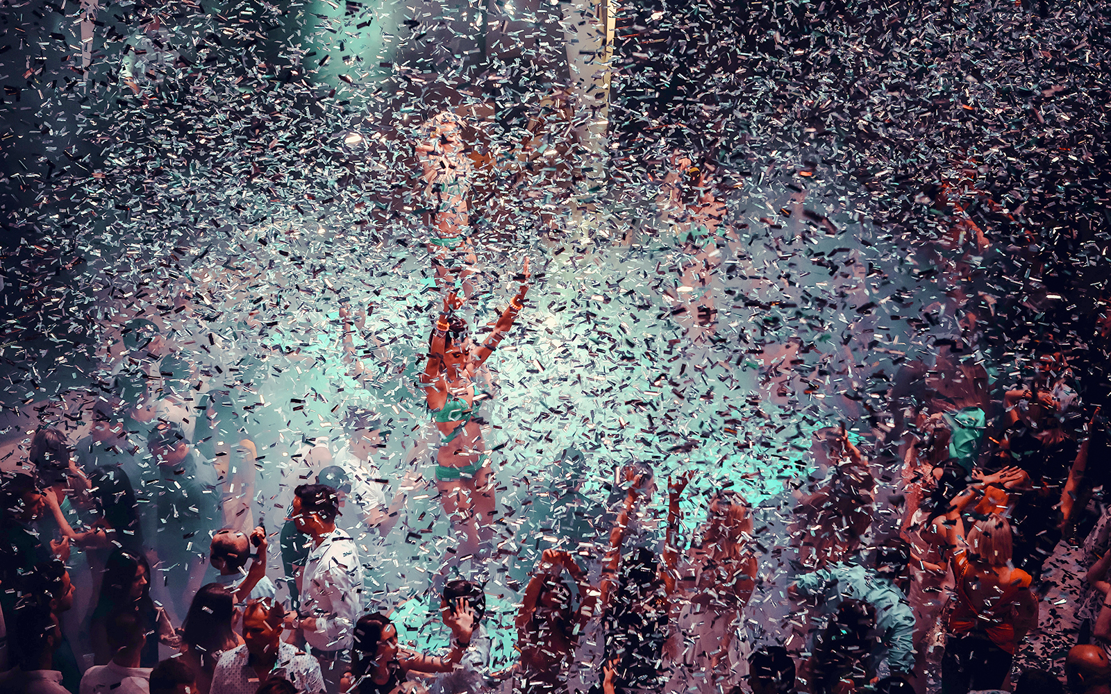 Confetti falling on a lively dance floor at a nightclub in Ibiza.
