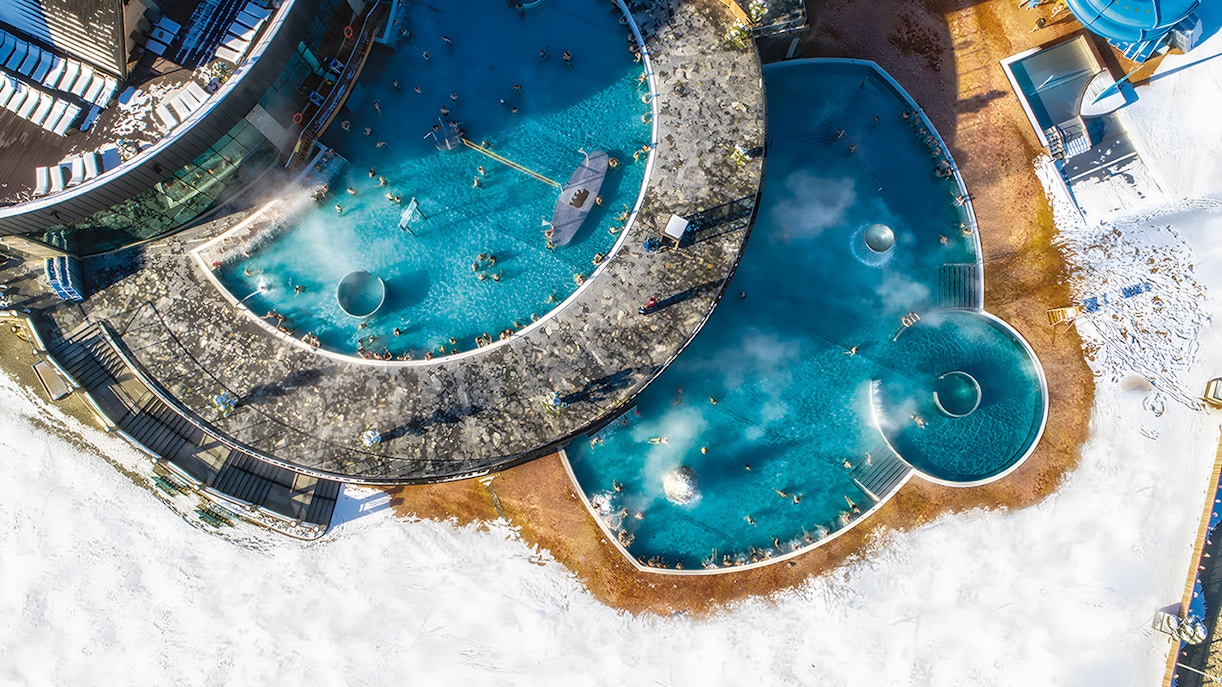 Aerial view of Chochołowska Baths in Zakopane with surrounding mountains.