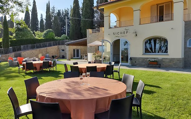 Outdoor dining setup for wine tasting and dinner in Chianti, Italy.