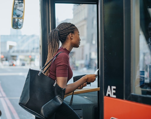 women getting on bus