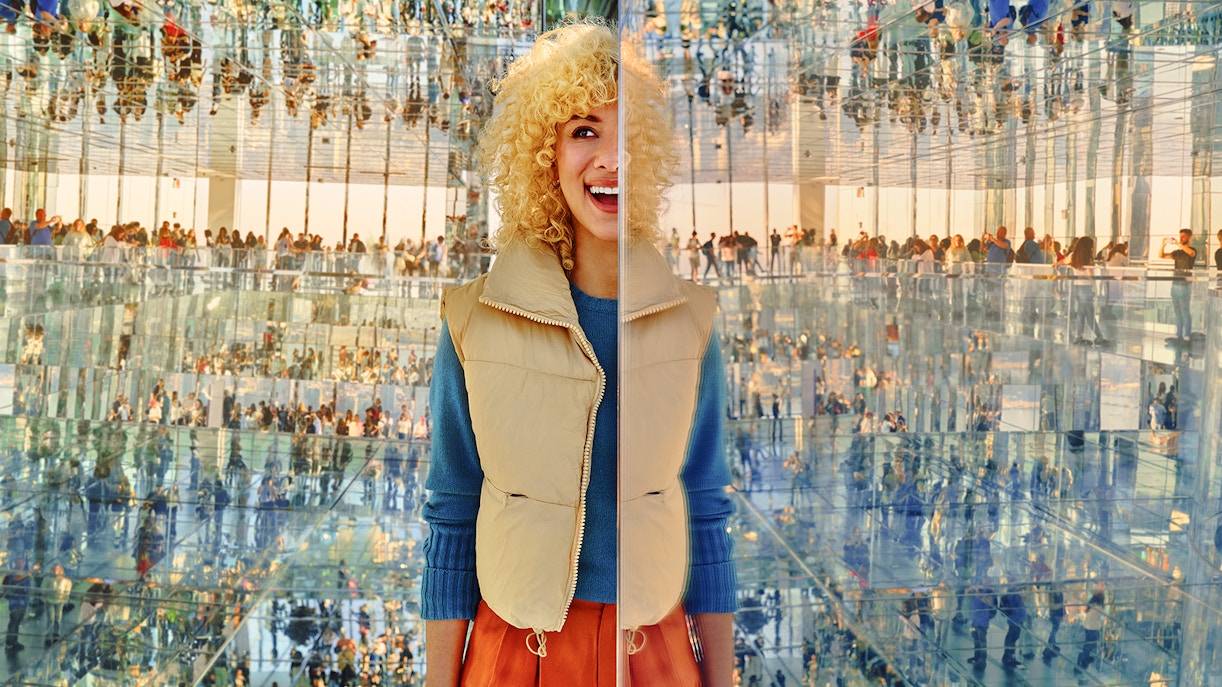 Woman seeing her many reflections through the immerive experience at AIR