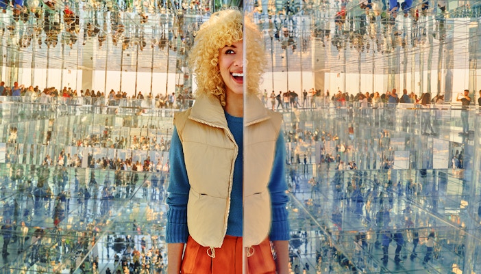 Woman seeing her many reflections through the immerive experience at AIR