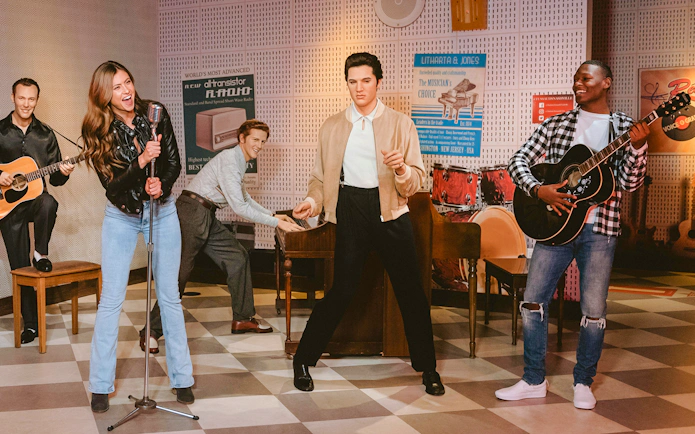 Guests interacting with wax figures of musicians at Madame Tussauds Nashville.