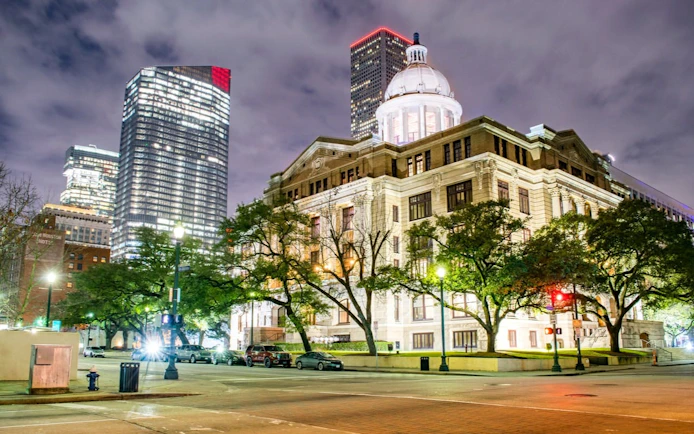 Historic Houston courthouse illuminated at night, part of Haunted Houston self-guided city exploration game.
