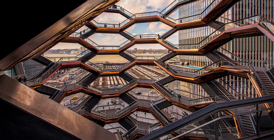 The Vessel in New York, showcasing its intricate honeycomb structure against a clear sky.