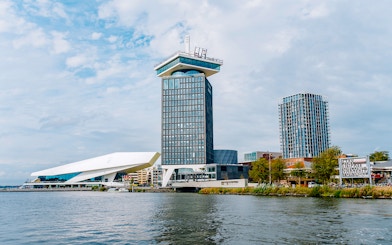 Adam Tower and surrounding buildings by the waterfront in Amsterdam.