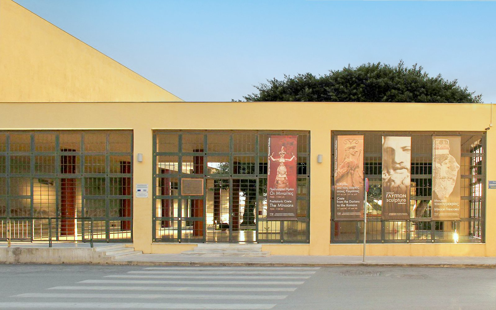 Heraklion Archaeological Museum entrance with banners displaying ancient artifacts.