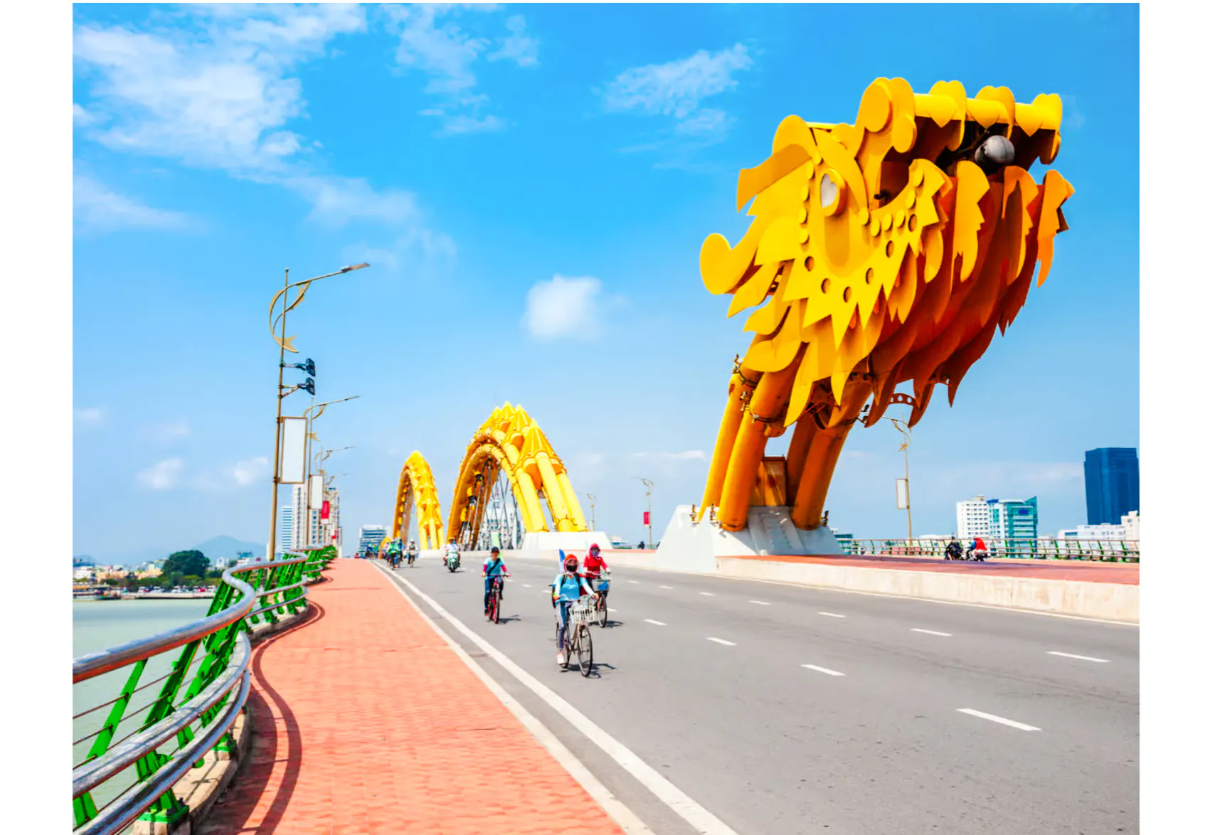 Dragon Bridge in Da Nang with cyclists on the road.