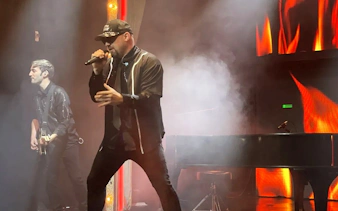 Tribute band performing Elton John and Billy Joel songs on stage with piano and guitar.