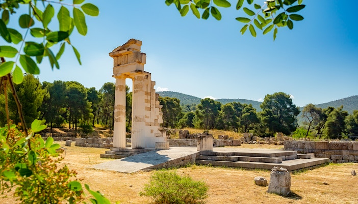 Ancient ruins at Epidaurus surrounded by trees, part of Nafplio-Mycenae-Epidaurus Day Tour.