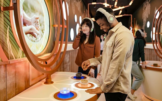 Tourists using audio guides at Pilsner Urquell The Original Beer Experience exhibit.